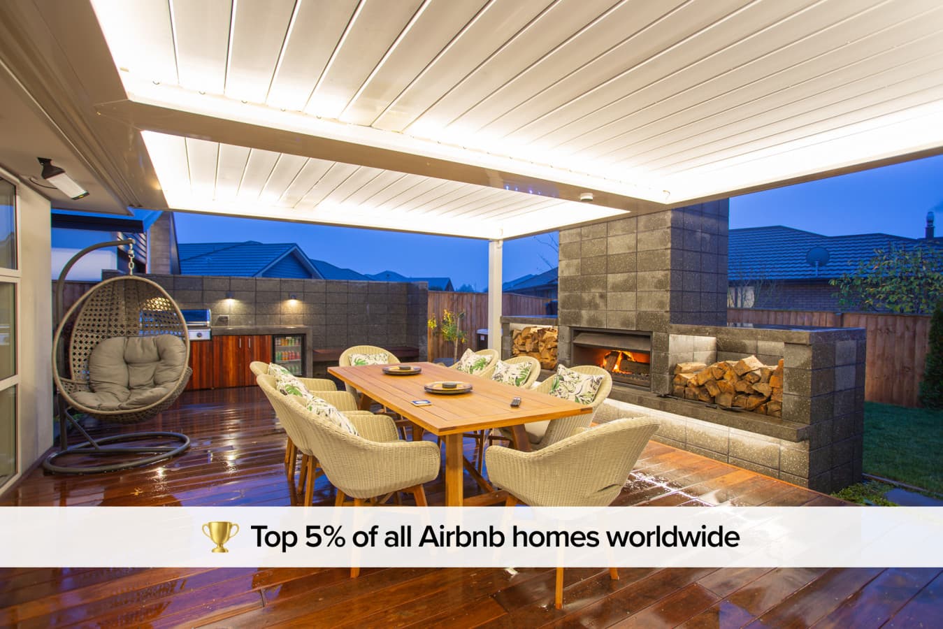 This outdoor living space is designed to bring people closer — with the spa, dining area, and fireplace creating beautiful holiday memories together.